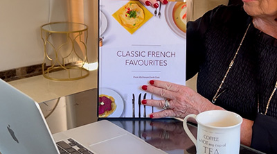 Placeholder for a video of an elegant lady flipping through a beautiful cookbook